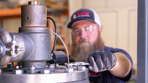 air compressor service technician changing a drop-in separator